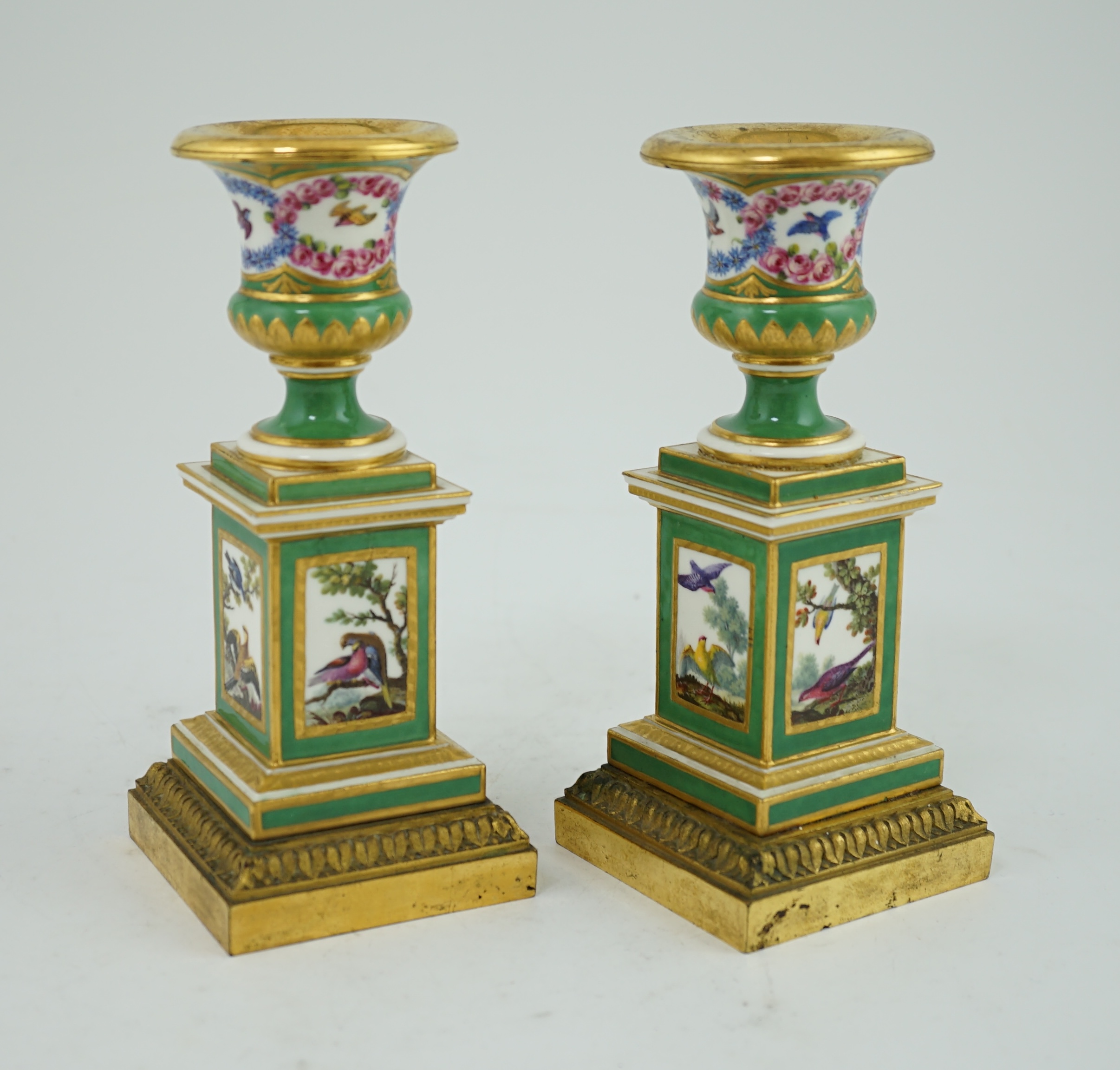 A pair of late 18th century Sevres ormolu mounted porcelain candlesticks, in the manner of Chappuis L'Aine